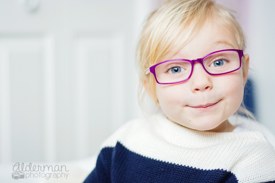 young girl wearing purple glasses